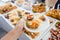 Man helping himself on Buffet of party outdoors taking food