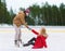 Man helping woman to rise up on skating rink