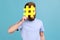 Man hiding face behind hashtag sign, calls on to tag topics on websites, giving recommendations.