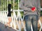 Man hiding red heart behind his back for his girlfriend. Love, Valentines Day Concept
