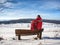 Man hiker with backpack in winter time walk