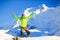 Man hiker happy jump in winter mountains