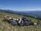 Man hiker in hat taking a nap at meadow with Mountain landscape of Western Tatra mountains or Rohace with view on high