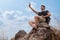 Man hiker having selfie on rock with blue sky background