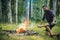 Man hiker make fire in forest