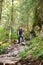 Man hiker on a marked trail through the forest