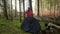 Man hiker sets up camping tent in the fall forest on backpacking expedition. Traveler setting an overnight tent in the