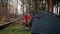 Man hiker sets up camping tent in the fall forest on backpacking expedition. Traveler setting an overnight tent in the