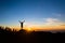 Man hiker silhouette with arms outstretched enjoy mountains