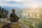 Man hiker sitting on top of mountain and contemplates beautiful view to the valley. Moment of Peace lettering.