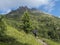 Man hiker with view on limestone moutain peaks and pine trees at Stubai Hohenweg, Alpine landscape of Tirol Alps