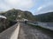 man hiker walking on the dam of Presa de Los Perez lake in Tamadaba nature park. Gran Canaria, Canary Islands, Spain