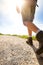 Man hiker walking on mountain rocks with sticks. Beautiful weather with Scotland nature. Detail of hiking boots on the difficult p