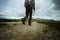 Man hiker walking towards mountain