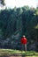 Man hiker in waterproof jacket admiring the cliff