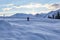 Man hikes snowy trails in Swiss Alps at dawn in winter