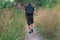 Man hiking with black backpack in summer