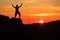 Man hiking climbing silhouette in sunset mountains