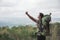 Man hiking in nature raise his arm