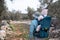 Man hiking in olive grove carrying baby in bacpack,sling,carrier.Family travelling,trips,lifestyle.Father and child