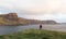 Man hiking through Scottish Highlands along rugged coastline