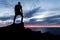 Man hiking silhouette in mountains, ocean and sunset