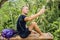 Man hiking taking selfie with smart phone. Happy young man taking self portrait with mountain scenery in background.