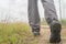 Man hiking walking follow trail path on pine tree forest in the mist at Phu Soi Dao national park