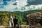 Man at hilltop watching the beautiful waterfall at evening