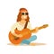 Man Hippie Dressed In Classic Woodstock Sixties Hippy Subculture Clothes Sitting Playing Guitar In Round Shades