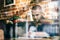 Man in his 30s sitting by the table, writing