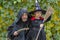 A man and his daughter dressed as a monk and a witch on Halloween, a family holiday.