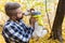 Man with his dog at autumn park. Guy playing with jack russell terrier outdoors. Pet and people concept.