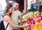 Man and his girlfriend buying apples