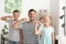 Man and his little children brushing teeth at home