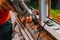 A man in his own house installs a plastic window, installs a new window, a worker uses an electric drill