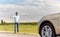 Man hitchhiking and stopping car at countryside