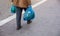 Man hoding blue plastic bags. Closeup view, copy space