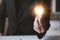 Man hold glowing light bulb, Creative new idea. Innovation, brainstorming, strategizing to make the business grow and be
