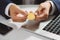 Man hold gold bitcoin over office desk. Bitcoin payment concept.