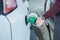 Man hold nozzle to fill fuel to car for travel