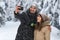 Man Hold Smart Phone Camera Taking Selfie Photo Young Romantic Couple Smile Snow Forest Outdoor