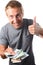 Man holding banknotes with the thumbs up gesture