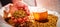 Man holding barley by beer glass in sack at brewery