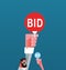 Man holding BID sign to buy from auction