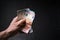 Man holding a bills of money. Euro currency on a black background. HandÂ´s of young man holding a money.