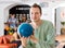 Man Holding Blue Bowling Ball in Club