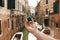 Man holding a blue box with engagement ring front venetian canal. An offer of marriage in Venice, Italy.