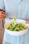 Man holding bowl alternative vegetable homemade zucchini pasta salad. Zoodle.