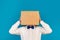 Man holding a box with both hands and his head inside